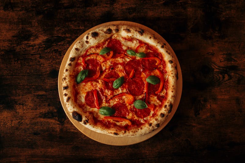 Pizza chef working at a wood-fired oven